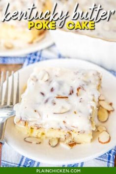 a white plate topped with cake covered in frosting and nuts next to a fork