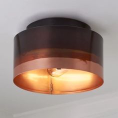 a close up of a light fixture on a ceiling in a room with white walls