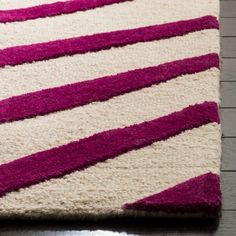 a purple and white rug on the floor