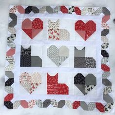 a quilted table topper with several hearts on it and the words i love you