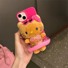 a person holding a hello kitty phone case in their hand