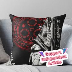 a black and red pillow with the words support independent artists on it