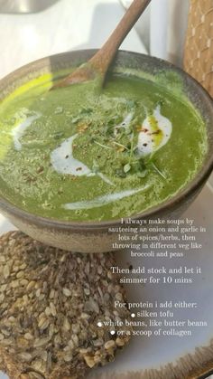 there is a bowl of green soup on the plate with a spoon in it and an article about how to use it