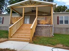 a porch with stairs leading up to the front door and covered patio area in an rv park