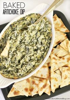 baked artichoke dip in a bowl with tortilla chips