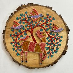 a wooden plaque with an animal and birds on it's side, in the shape of a tree