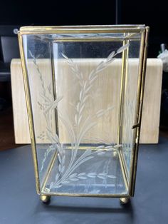 a glass vase sitting on top of a table