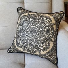 a black and white pillow sitting on top of a couch