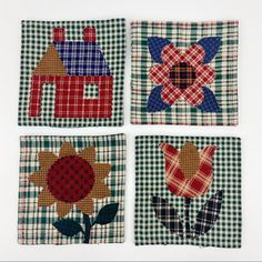 four squares with different designs on them, one has a house and the other has a flower