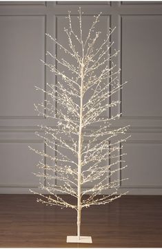 a white christmas tree with lights on it