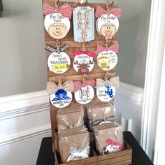 a wooden stand with many different items on it and tags attached to the top of each item