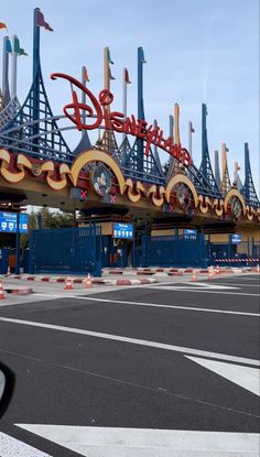 the entrance to an amusement park with many signs on it