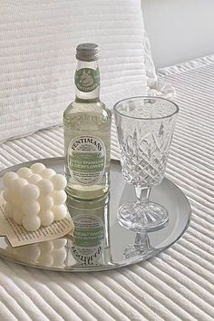 a bottle of alcohol and some marshmallows on a tray