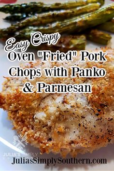 fried pork chops with parmesan and asparagus on a white plate