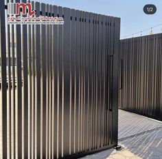 a large metal gate with vertical slats on it