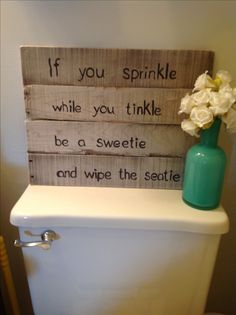 a wooden sign that says if you sprinkle while you tinkle be a sweetie and wipe the seate