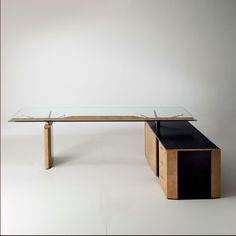 a glass and wood table on a white background with an empty shelf below the table