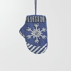 an ornament hanging from a string with snowflakes on it