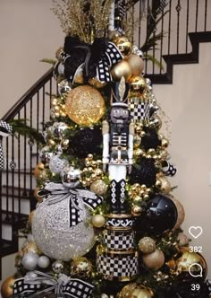 a christmas tree decorated with black and gold ornaments