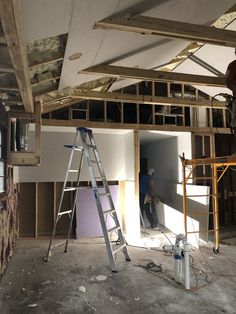 a man standing on a ladder in an unfinished room that is being built into the ceiling