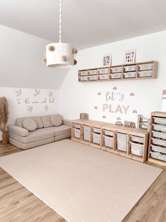 a living room filled with lots of furniture and storage boxes on the wall next to a couch