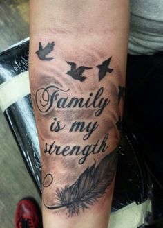 a person with a tattoo on their arm that says family is my strength and birds are flying around