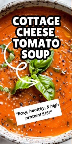 a bowl of tomato soup with basil leaves on top and the words cottage cheese tomato soup