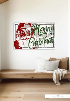 a merry christmas sign hanging on the wall above a wooden bench in a living room