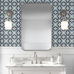 a bathroom vanity with two sinks and a large mirror above it, in front of a blue patterned wall