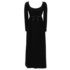 This Geoffrey Been black gown from the 1960's is feminine and demure with its empire waist and sweet satin bow. Scoop neck, with slight gather at shoulders, long narrow sleeves with satin trimmed wrists. Fabric covered button closure all the way down the front of the dress add a girly touch. Excellent vintage condition. Small fit through hips. Size 2 US. Empire Waist Dresses, Black Empire Waist Dress, Geoffrey Beene Dress, Black Velvet Gown, Empire Waist Gown, Gowns Black, 1960s Dresses, Long Evening Dresses, Velvet Gown