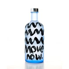 a glass bottle with black and white designs on the top is shown in front of a white background