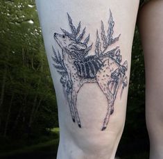 a woman's leg with a deer tattoo on it