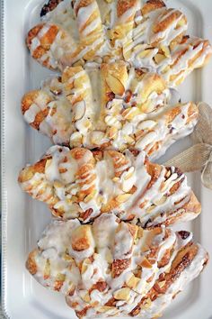 a white plate topped with pastry covered in icing