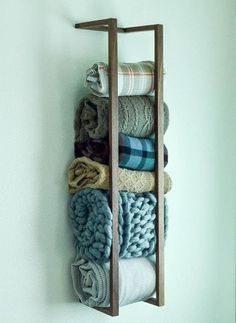 a wooden rack holding towels and blankets