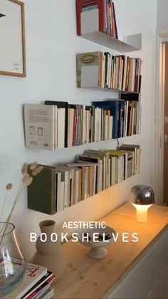 a bookshelf filled with lots of books next to a lamp