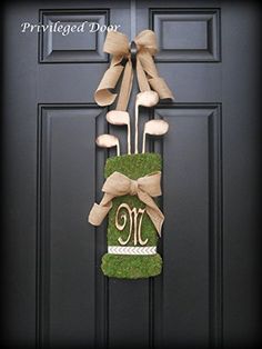 a door hanger decorated with grass and golf tees