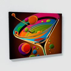 an abstract painting on a white wall with a martini glass and spoons in it