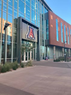 the front entrance to an office building with large glass windows and a sign that says aa on it