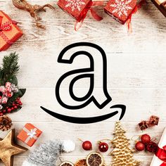 an amazon logo surrounded by christmas presents and gifts on a white wooden background with red ribbon