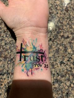 a person's wrist with a tattoo on it and the words trust in black ink