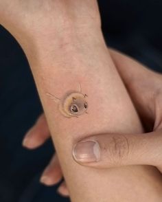 a small insect tattoo on the wrist