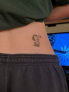 a person with a small tattoo on their stomach