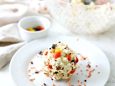 a white plate topped with popcorn and sprinkles