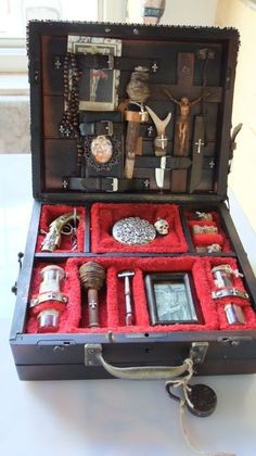 an open suitcase with various items inside it on a table in front of a window