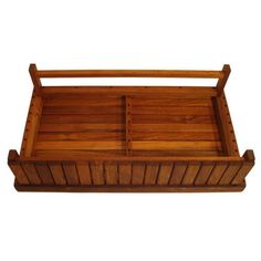 a wooden tray with two compartments on the bottom and one in the middle, against a white background