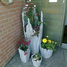 several potted plants sitting on the side of a building