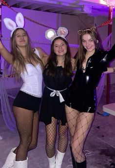 three girls dressed up in bunny ears posing for the camera