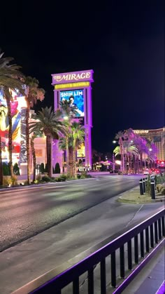 the mirage hotel and casino in las vegas is lit up with purple lights at night