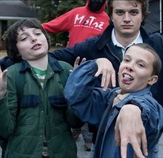 three young men standing next to each other