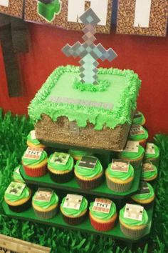 a cake and cupcakes are on display in the grass at a minecraft themed birthday party